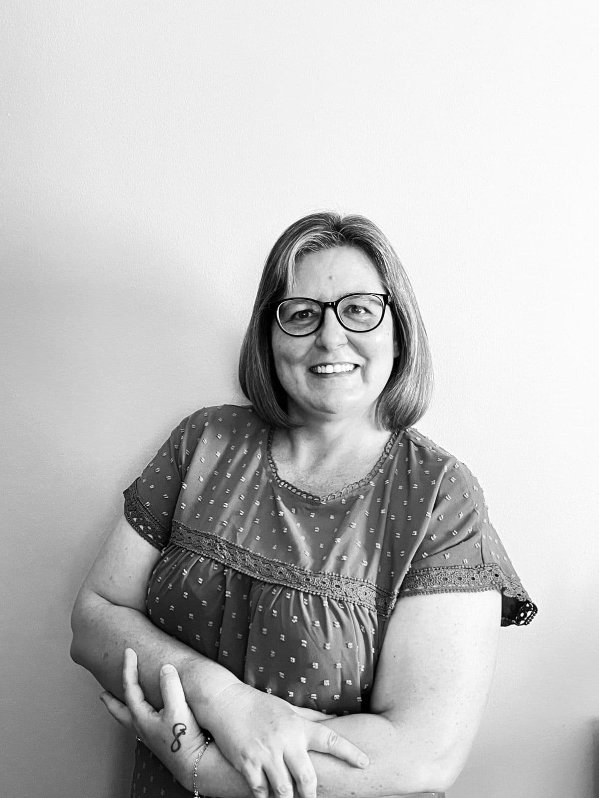 Tracey Flavell, founder of Influenced VA, smiling with arms folded